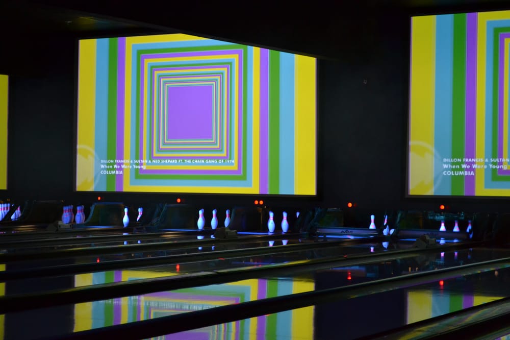 a bowling alley with large video screens